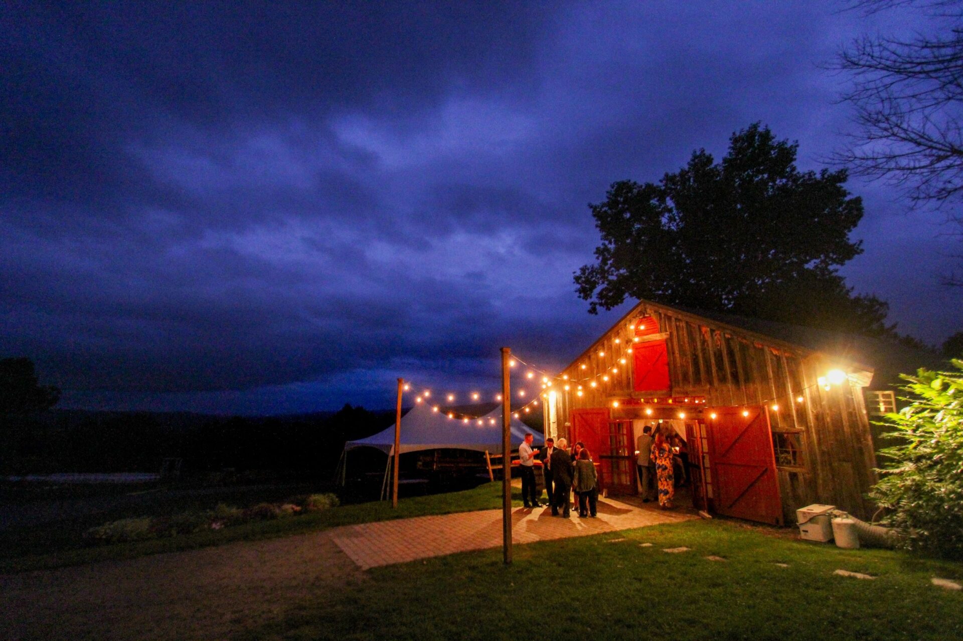 Outdoor patio at Longlook Farm in Vermont lit with warm bistro string lights at night