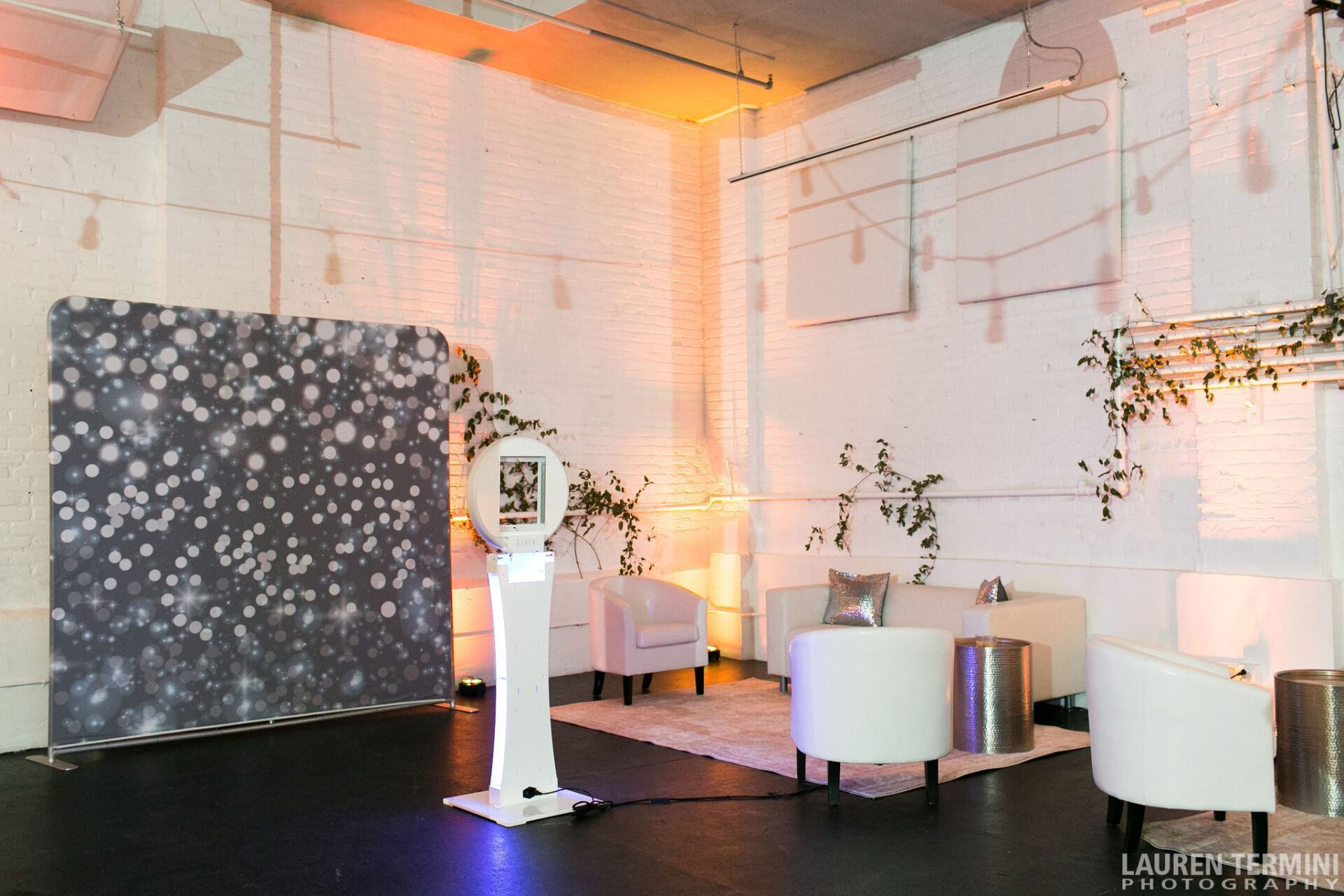 Full VIP lounge setup at a New England wedding venue with white seating pods and accent lighting