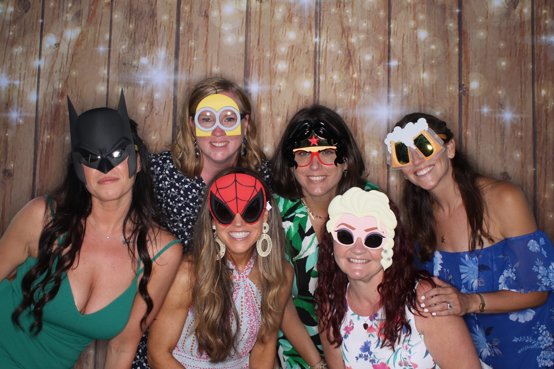 Wedding guests using the open air photo booth with props at a Boston reception