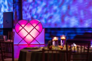 Custom pink heart-shaped DJ booth fabricated by Black Diamond Event Production for a wedding reception