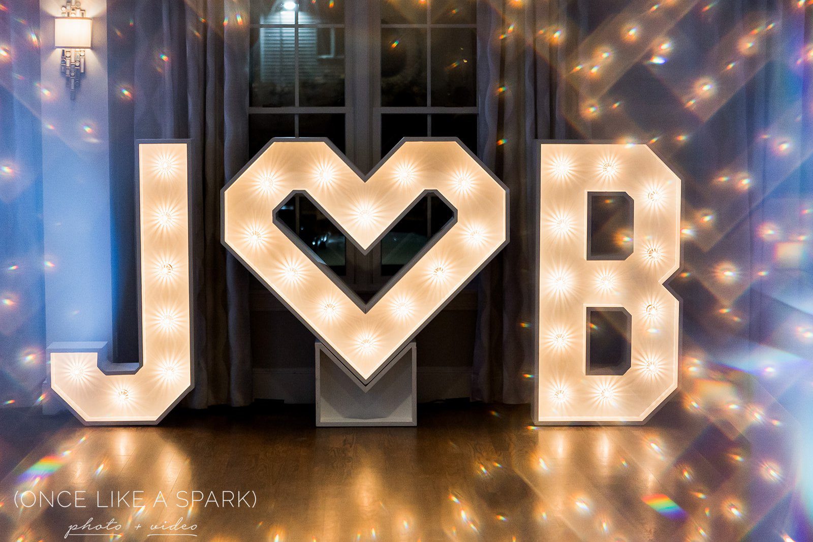 Marquee light letter initials at a New England wedding