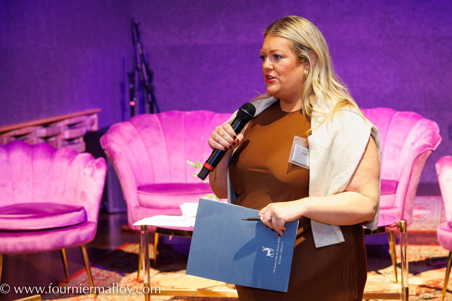 Corporate event staging and presenter panel with stage lighting