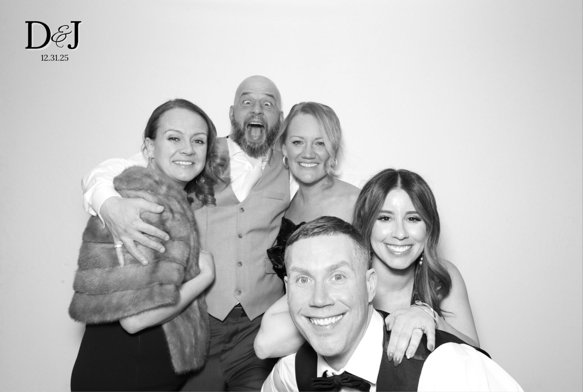 Guests posing at a Black Diamond GLAM photo booth at a luxury Boston wedding reception