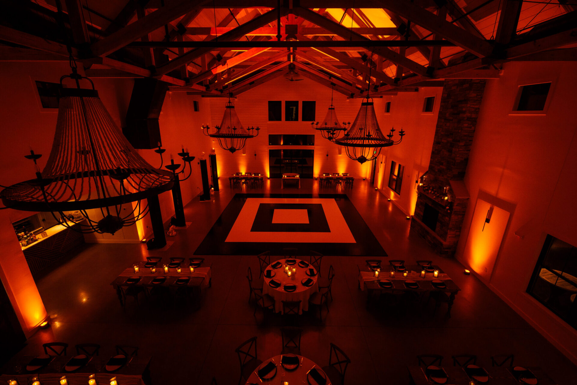Concentric ring black and white dance floor with amber uplighting at a luxury Boston gala