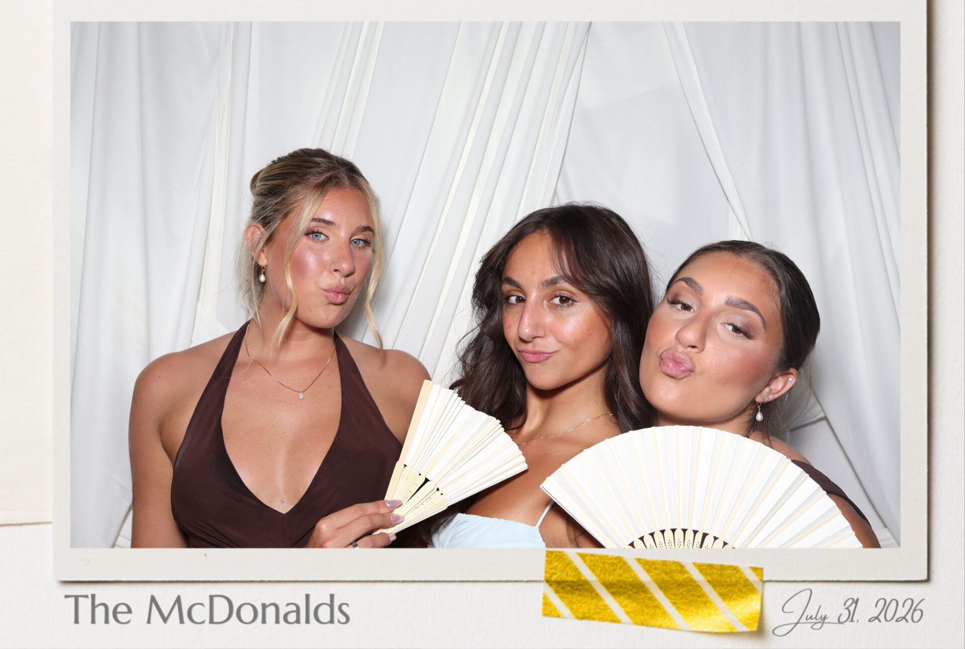 Three guests posing with fans in an ultra high resolution 4x6 portrait print photo booth, custom name and date border, Black Diamond Event Production